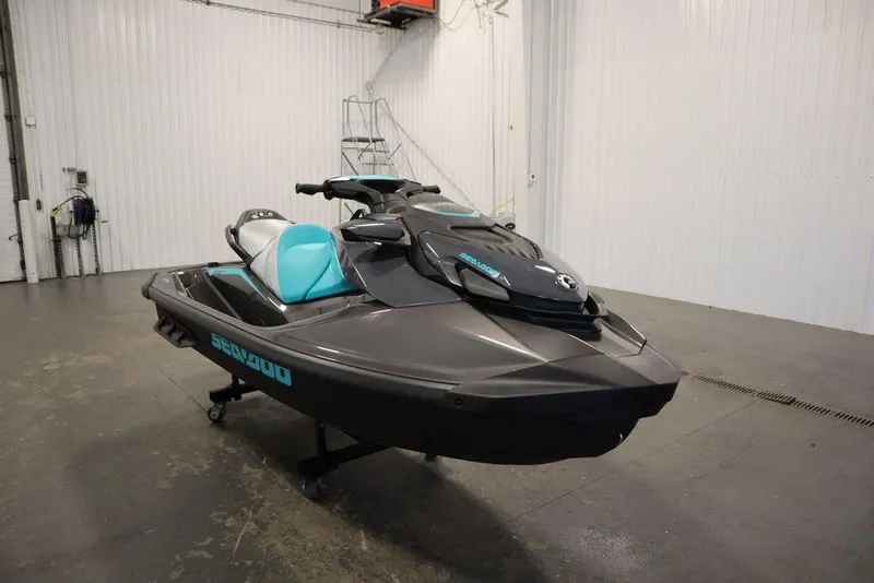Slide: The Image of 2025 Sea-Doo GTR 230 jet ski in a garage, featuring sleek design and turquoise accents. - 5