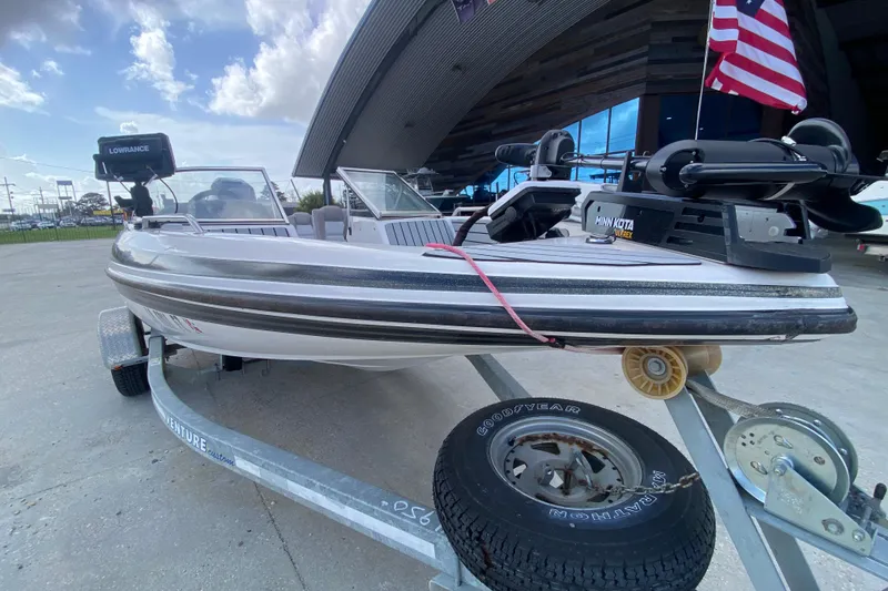 Slide: The Image of 2002 Skeeter SL 190 boat on trailer with American flag and Lowrance equipment. - 10