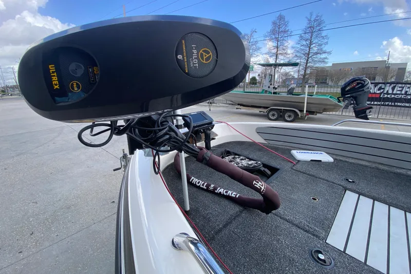 Slide: The Image of 2002 Skeeter SL 190 boat with Ultrex trolling motor and i-Pilot system, docked outdoors. - 12