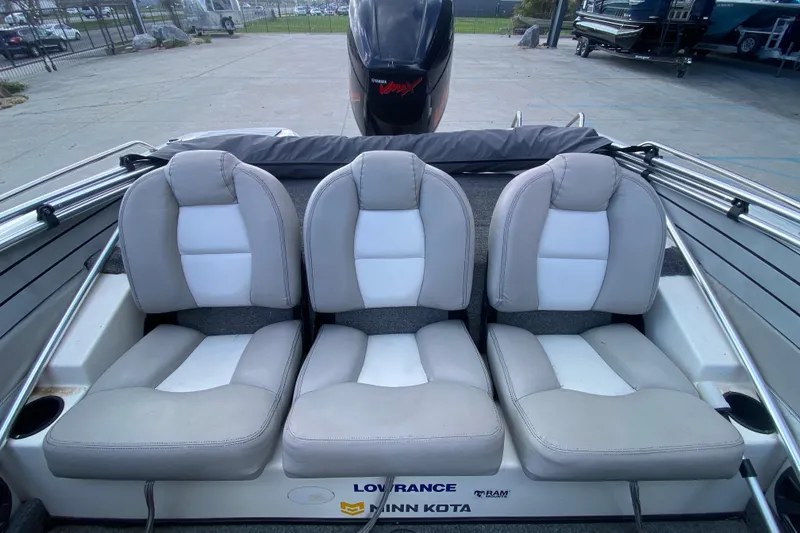 Slide: The Image of 2002 Skeeter SL 190 boat interior with three cushioned seats and motor. - 14
