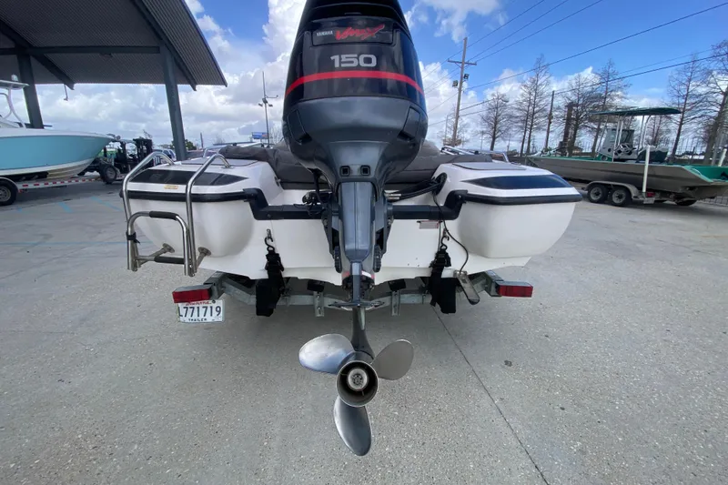 Slide: The Image of 2002 Skeeter SL 190 boat with Yamaha 150 engine, parked outdoors. - 5
