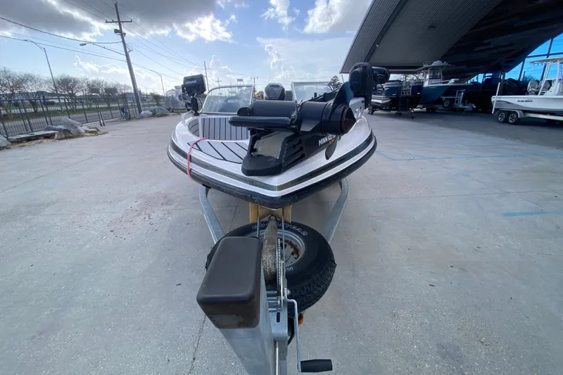 Slide: The Image of 2002 Skeeter SL 190 boat on trailer, parked outdoors under a cloudy sky. - 9