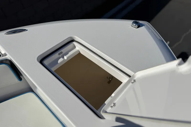 Slide: The Image of 2024 Aquasport 2200 Center Console boat storage compartment open. - 10