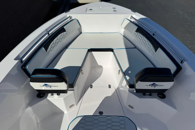 Slide: The Image of 2024 Aquasport 2200 Center Console boat interior with cushioned seating and sleek design. - 11