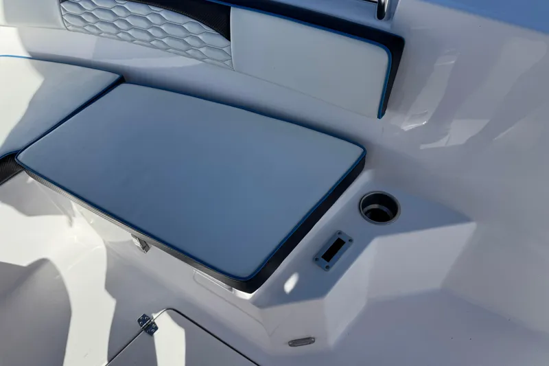 Slide: The Image of 2024 Aquasport 2200 Center Console boat seating area with cup holder and storage. - 12