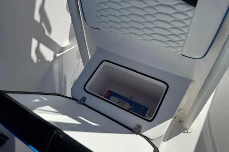 Slide: The Image of 2024 Aquasport 2200 Center Console storage compartment with textured interior design. - 15
