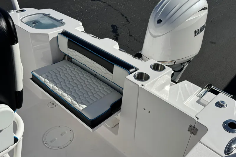 Slide: The Image of 2024 Aquasport 2200 Center Console boat interior with seating and Yamaha engine. - 20