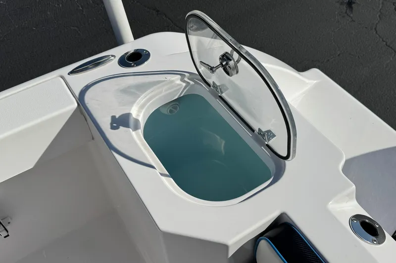 Slide: The Image of 2024 Aquasport 2200 Center Console livewell with open lid, showcasing interior design. - 22