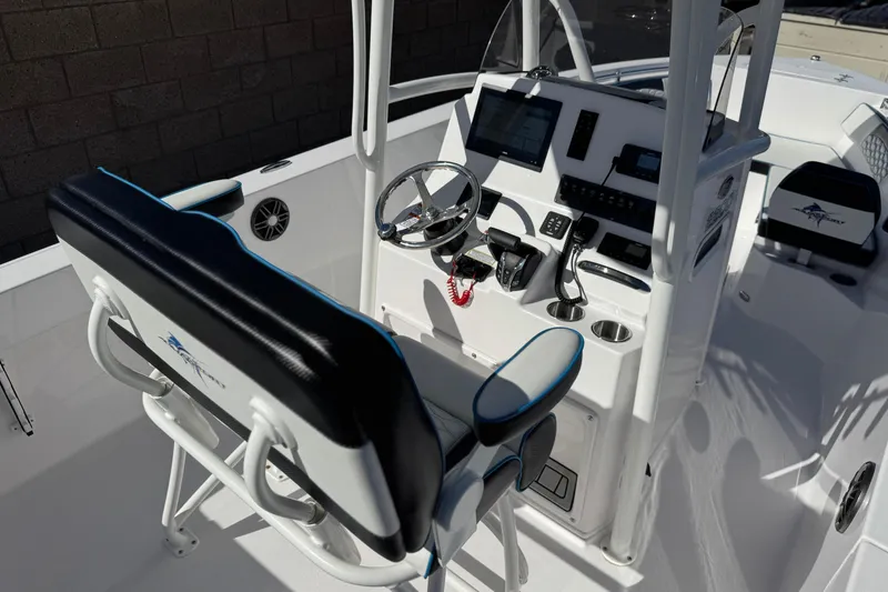 Slide: The Image of 2024 Aquasport 2200 Center Console boat interior with steering wheel and control panel. - 24