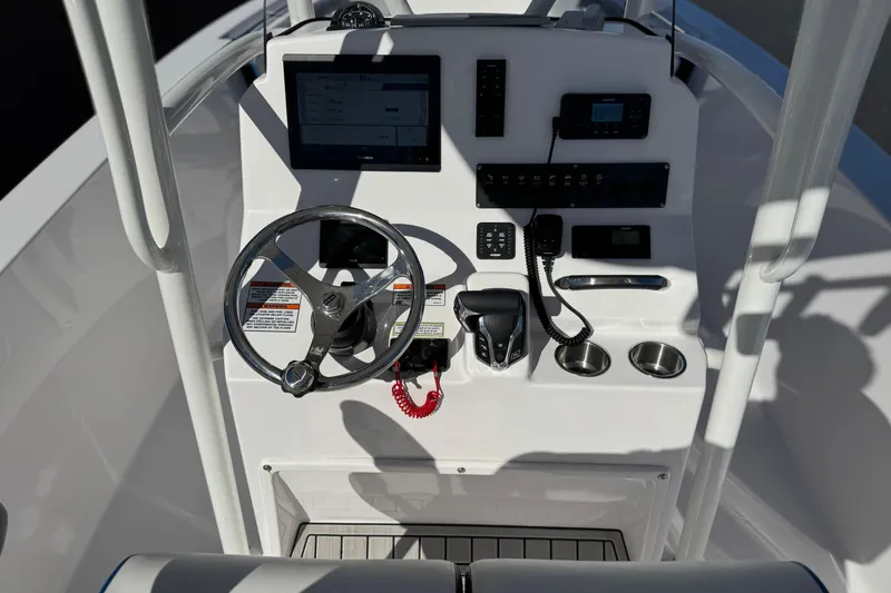 Slide: The Image of 2024 Aquasport 2200 Center Console boat dashboard with steering wheel and controls. - 25