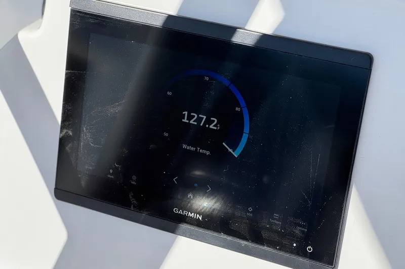 Slide: The Image of Garmin display showing water temperature on 2024 Aquasport 2200 Center Console boat. - 27