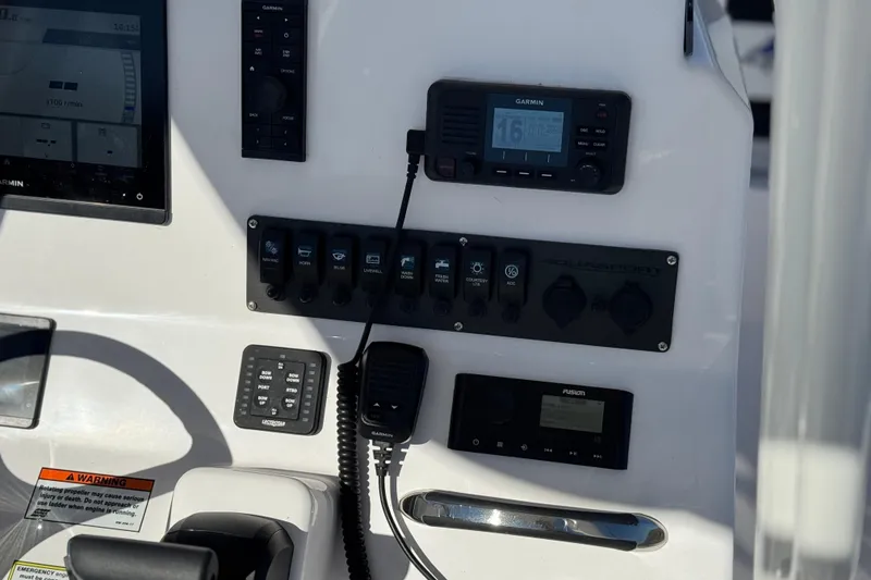 Slide: The Image of 2024 Aquasport 2200 Center Console dashboard with Garmin and Fusion electronics. - 30