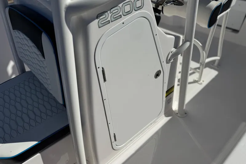 Slide: The Image of 2024 Aquasport 2200 Center Console boat interior with seating and storage compartment. - 31