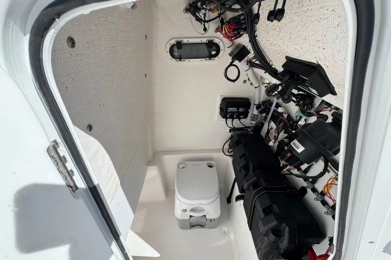 Slide: The Image of 2024 Aquasport 2200 Center Console interior wiring and equipment compartment. - 32