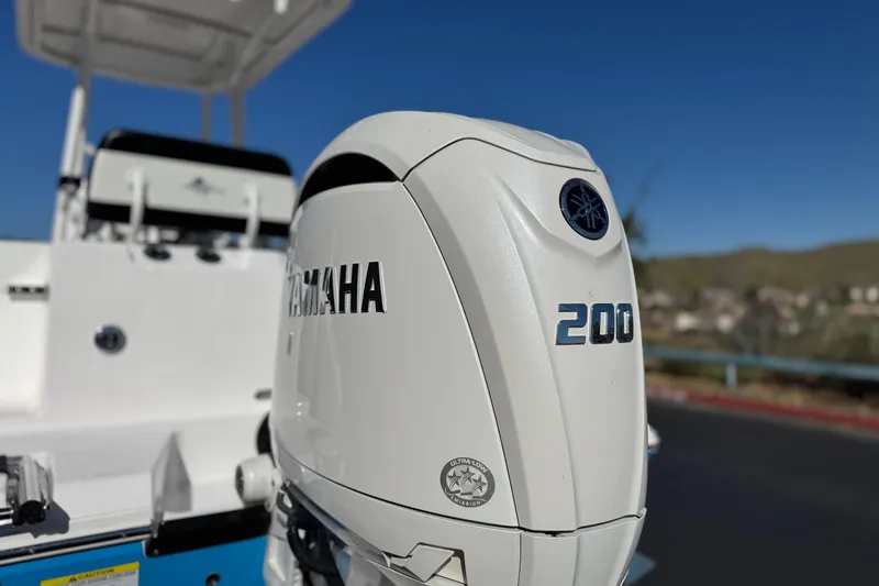 Slide: The Image of 2024 Aquasport 2200 Center Console with Yamaha 200 outboard motor, sunny day. - 7