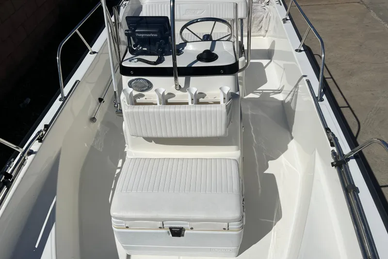 Slide: The Image of 2016 Boston Whaler 170 Montauk boat interior with steering console and seating. - 12