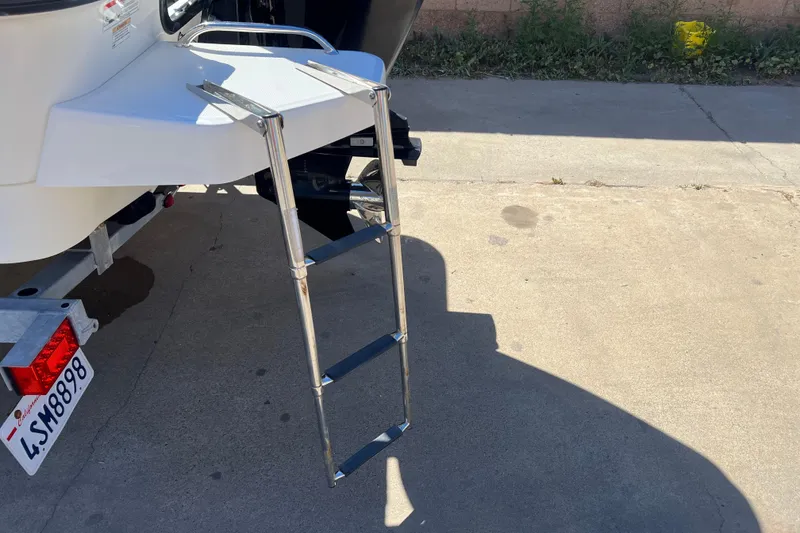 Slide: The Image of 2016 Boston Whaler 170 Montauk boat ladder extended on concrete surface. - 17