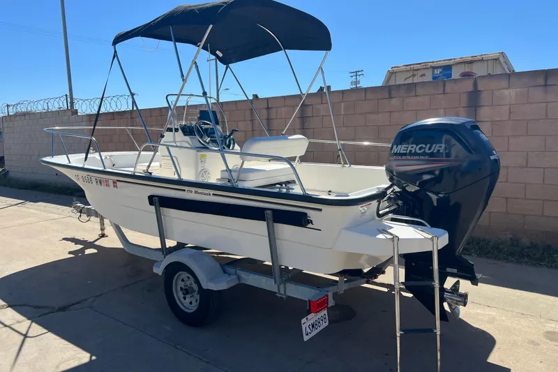 Slide: The Image of 2016 Boston Whaler 170 Montauk boat with Mercury engine on trailer. - 3