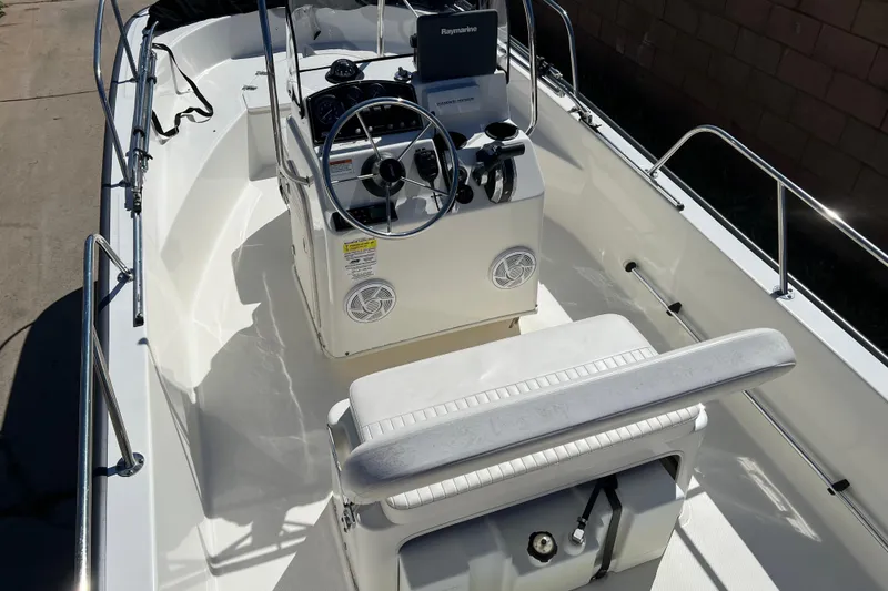 Slide: The Image of 2016 Boston Whaler 170 Montauk boat interior with steering console and seating. - 6