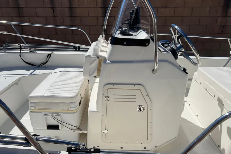 Slide: The Image of 2016 Boston Whaler 170 Montauk boat interior with steering console and seating. - 7