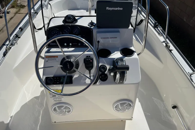 Slide: The Image of 2016 Boston Whaler 170 Montauk boat console with steering wheel and navigation equipment. - 8