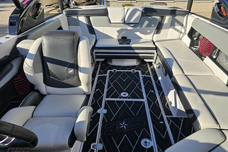 Slide: The Image of Interior of a 2015 Nautique Super Air Nautique G23 boat, featuring luxurious seating and sleek design. - 108