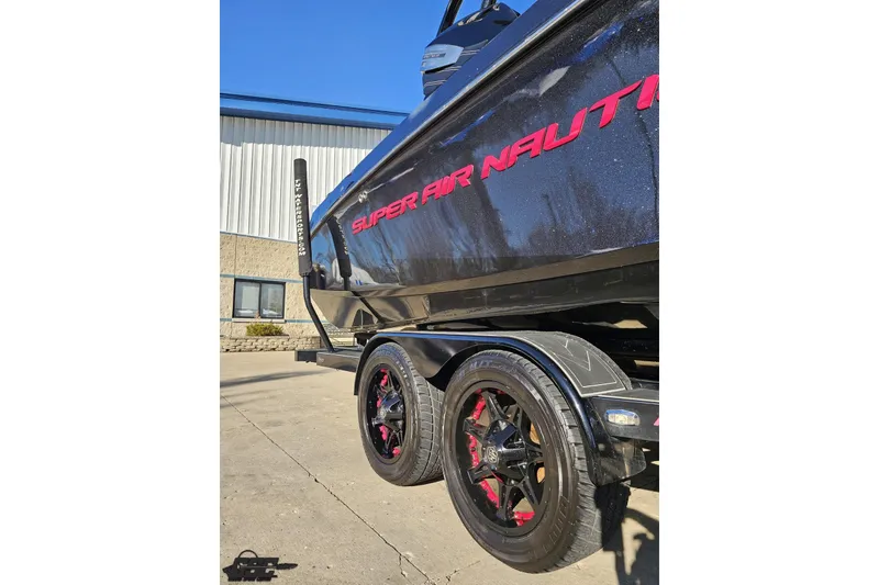 Slide: The Image of 2015 Nautique Super Air Nautique G23 boat on trailer, black with red accents. - 11