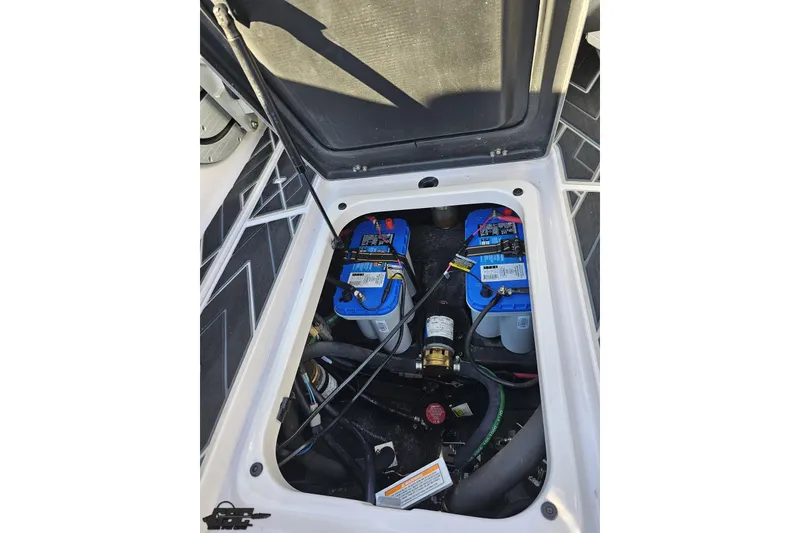 Slide: The Image of 2015 Nautique Super Air Nautique G23 battery compartment with dual batteries and wiring. - 121