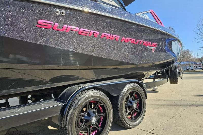 Slide: The Image of 2015 Nautique Super Air Nautique G23 boat on trailer, glittery finish, pink accents. - 13
