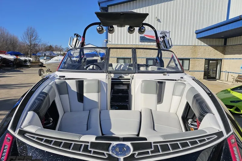 Slide: The Image of 2015 Nautique Super Air Nautique G23 boat with spacious seating, parked outdoors. - 20