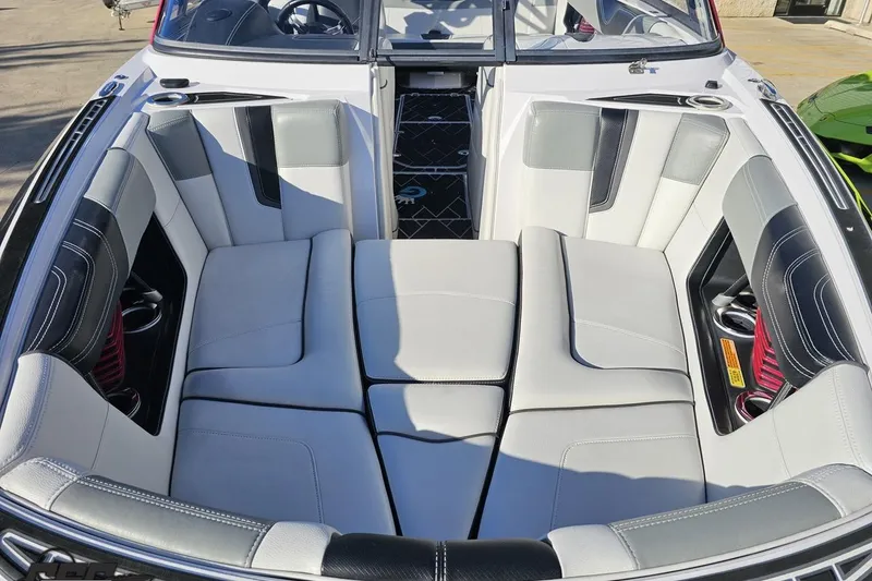 Slide: The Image of 2015 Nautique Super Air Nautique G23 boat interior with luxurious seating and cup holders. - 22