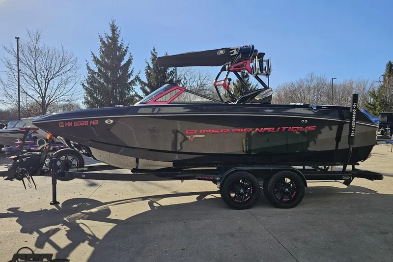 Slide: The Image of 2015 Nautique Super Air Nautique G23 boat on trailer, parked outdoors. - 26