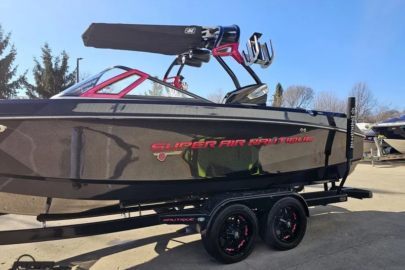 Slide: The Image of 2015 Nautique Super Air Nautique G23 boat on trailer, sleek black design. - 27