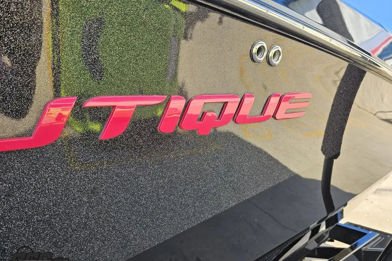 Slide: The Image of 2015 Nautique Super Air Nautique G23 boat with glittery finish and bold pink logo. - 29