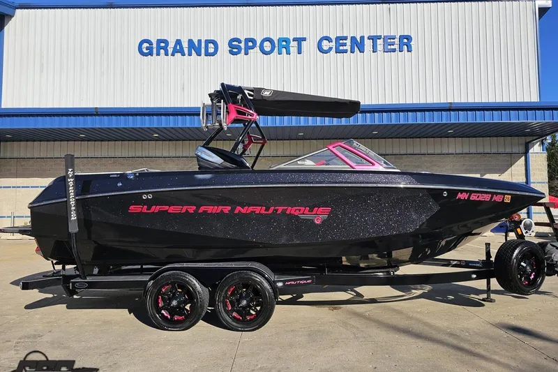 Slide: The Image of 2015 Nautique Super Air Nautique G23 boat at Grand Sport Center, black with pink accents. - 4