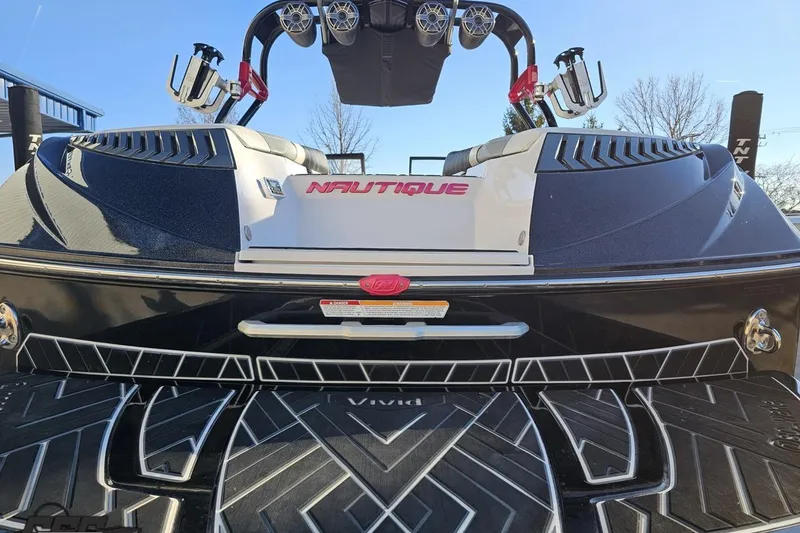 Slide: The Image of 2015 Nautique Super Air Nautique G23 boat rear view with sleek design and logo. - 41