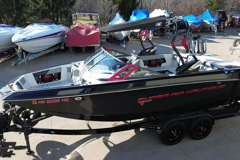 Slide: The Image of 2015 Nautique Super Air Nautique G23 boat on trailer, parked outdoors. - 48