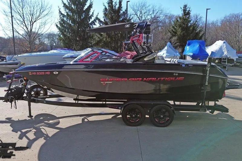 Slide: The Image of 2015 Nautique Super Air Nautique G23 boat on trailer, parked outdoors. - 49