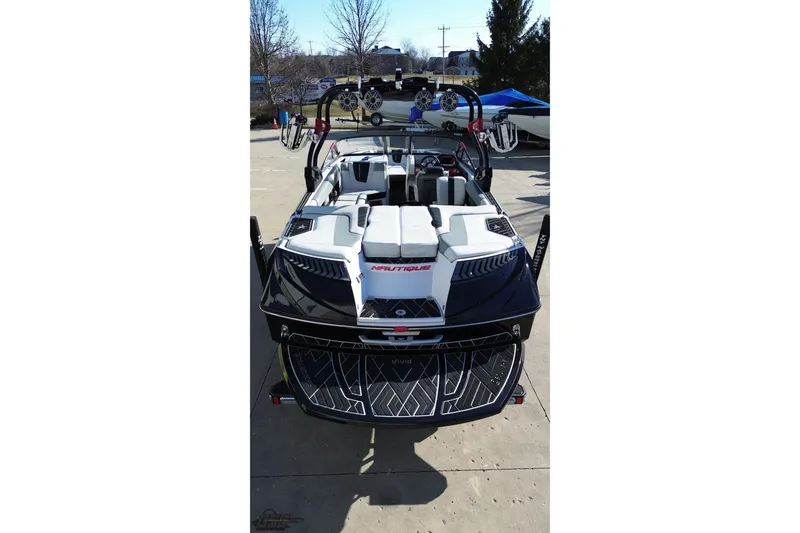 Slide: The Image of 2015 Nautique Super Air Nautique G23 boat, black and white, parked on concrete. - 52