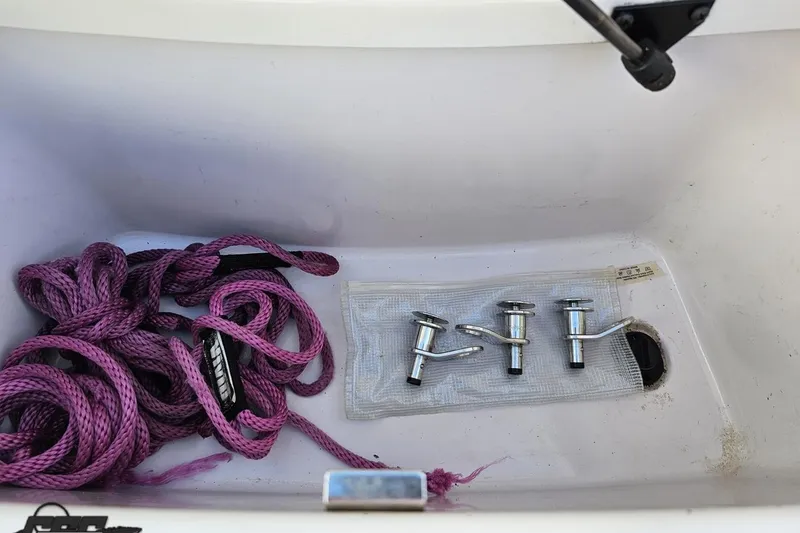 Slide: The Image of Purple rope and metal fittings in 2015 Nautique Super Air Nautique G23 storage compartment. - 59
