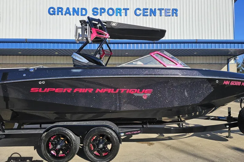 Slide: The Image of 2015 Nautique Super Air Nautique G23 boat at Grand Sport Center, black with pink accents. - 6