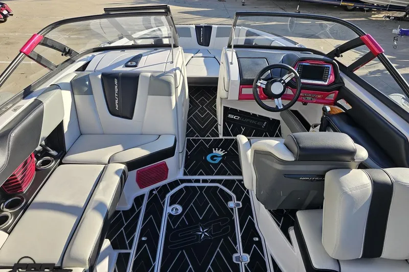 Slide: The Image of Interior of 2015 Nautique Super Air Nautique G23 boat with modern seating and dashboard. - 68