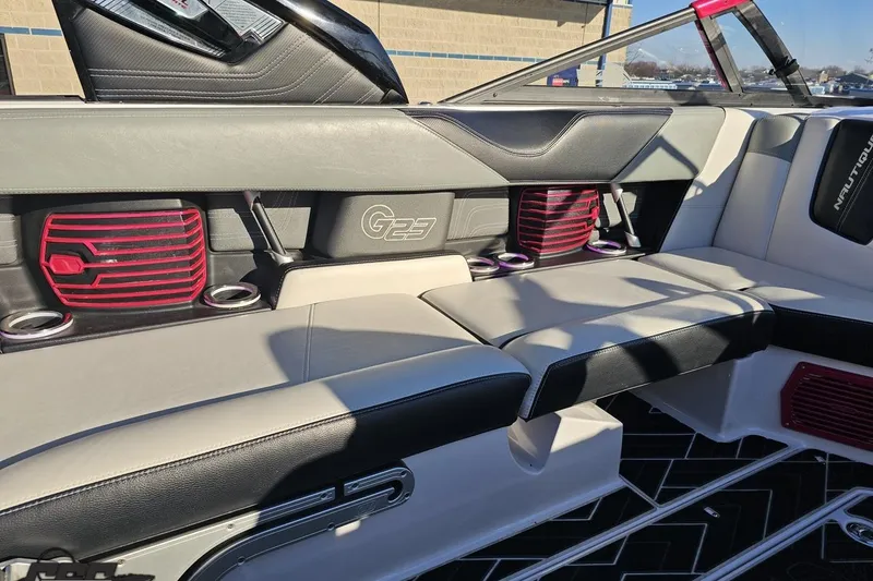 Slide: The Image of 2015 Nautique Super Air Nautique G23 interior with stylish seating and red speaker accents. - 72