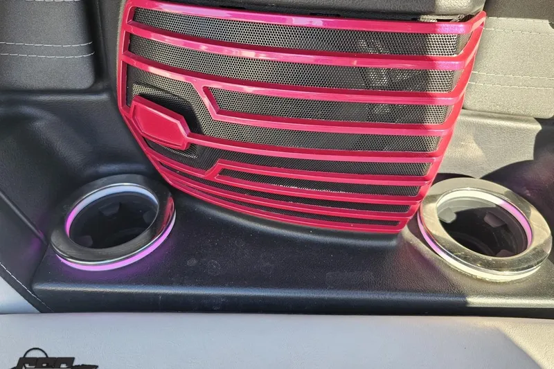 Slide: The Image of Interior detail of 2015 Nautique Super Air Nautique G23 with red speaker grille and cup holders. - 73