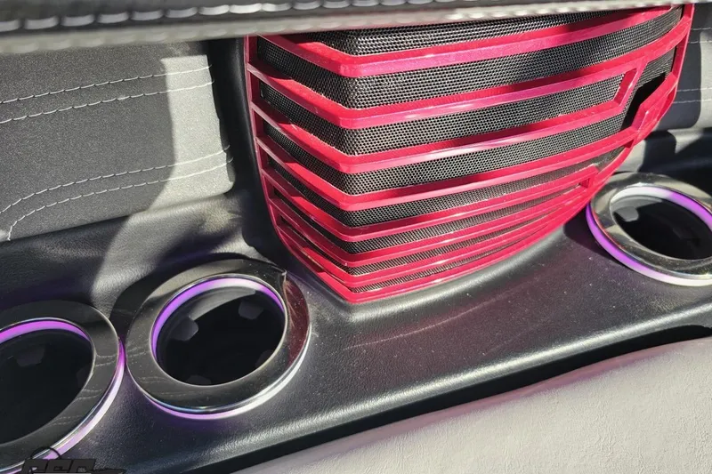 Slide: The Image of Interior detail of 2015 Nautique Super Air Nautique G23 with red speaker grille and cup holders. - 74