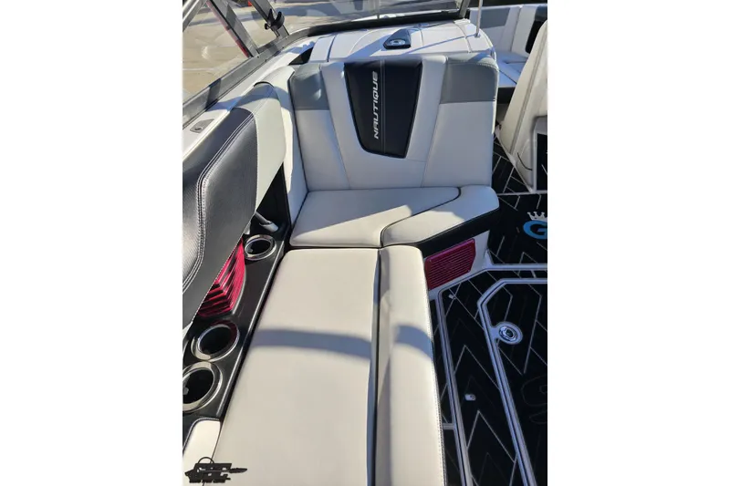 Slide: The Image of 2015 Nautique Super Air Nautique G23 interior seating with cup holders and stylish design. - 75