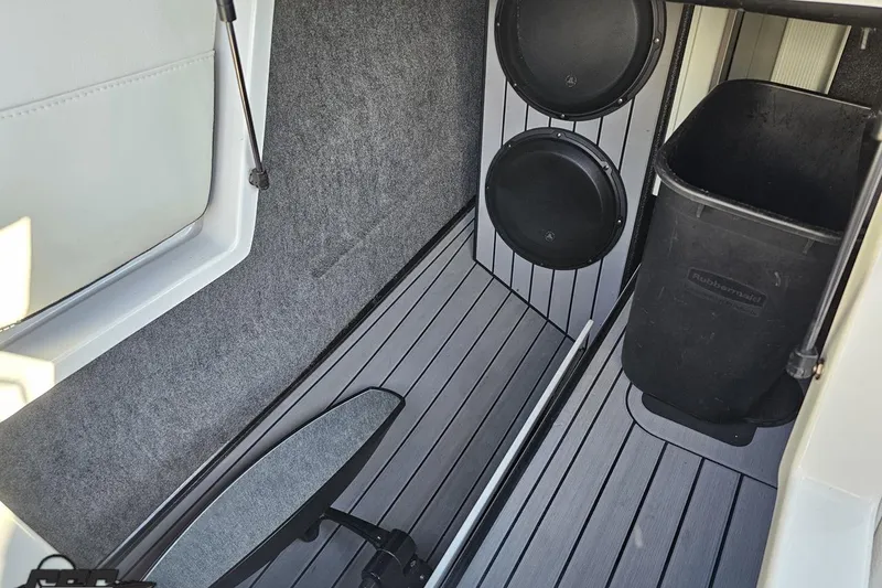 Slide: The Image of 2015 Nautique Super Air Nautique G23 interior with speakers and storage area. - 79