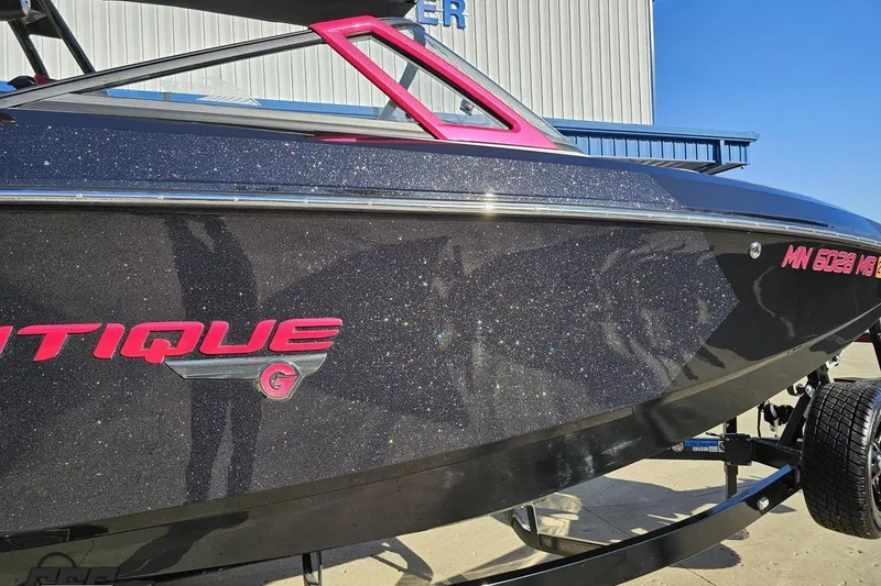 Slide: The Image of 2015 Nautique Super Air Nautique G23 boat with sparkling black finish and pink accents. - 8