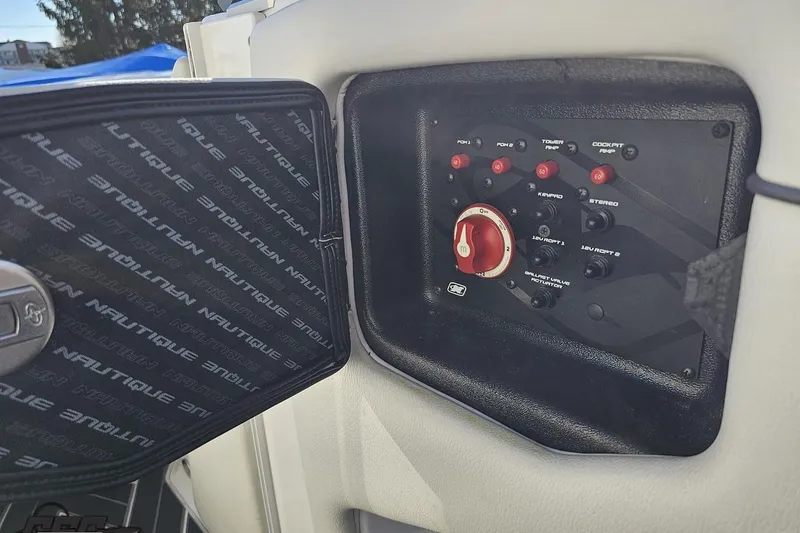 Slide: The Image of Control panel of 2015 Nautique Super Air Nautique G23 boat with switches and dials. - 83
