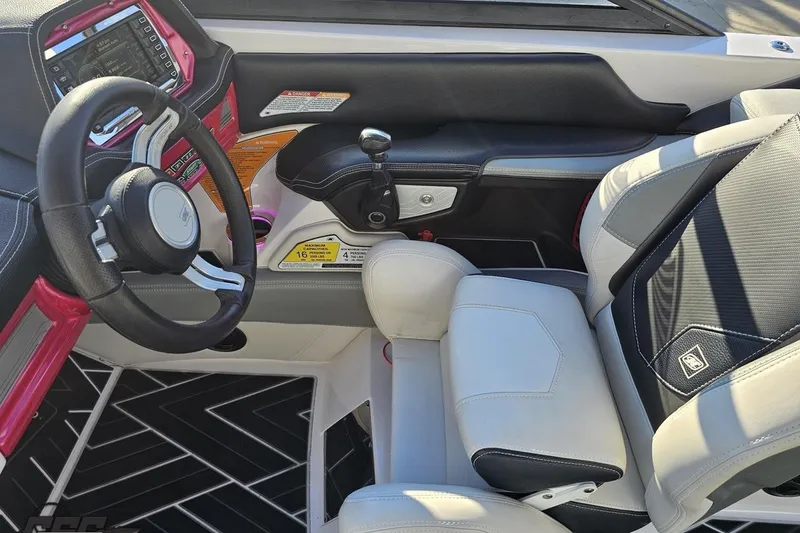 Slide: The Image of 2015 Nautique Super Air Nautique G23 boat interior with steering wheel and captain's seat. - 85
